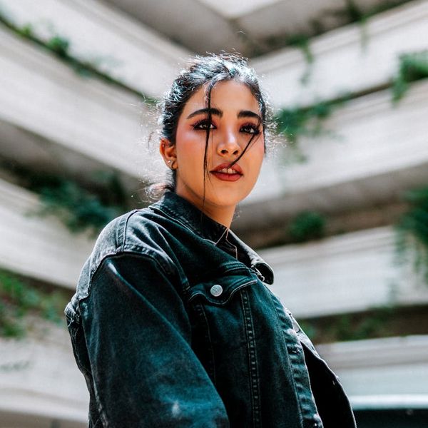 Woman performing an energetic yoga pose, looking vibrant and strong.